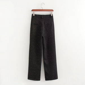 Détail du pantalon large en tweed montrant les poches et la texture brodée de sequins blancs