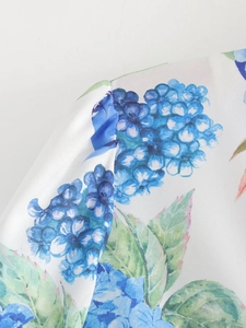 Detailed close-up of blue hydrangea floral print and high-quality seam on summer dress