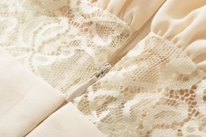 Detailed view of apricot dress featuring intricate lace crochet and invisible zipper
