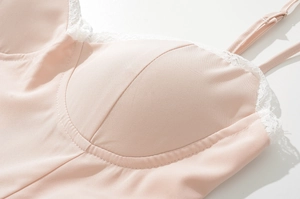 Close-up of pink camisole with built-in padded cups and delicate white lace trim details