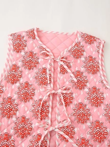 Detalle del chaleco acolchado rosa con estampado de flores y bordes a rayas finas