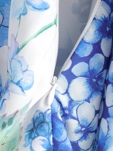 Detailed close-up showing the invisible zipper and blue floral print fabric texture
