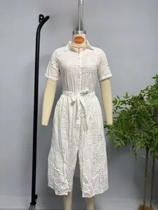 Close-up of white midi dress showing floral embroidery and button-down shirt collar detail