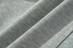 Macro detail of high-quality grey knit fabric with elastic twill texture for casual shorts