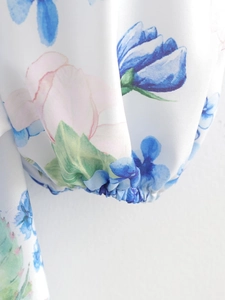 Detail of elastic cuff on floral print dress with blue and pink watercolor pattern