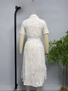 Detail of white short sleeve lace embroidery dress with intricate hollow-out floral patterns