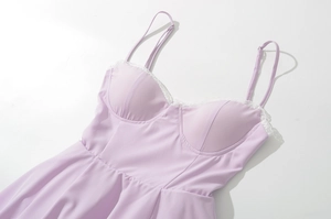 Detail of lavender camisole dress featuring white lace trim and padded cups texture