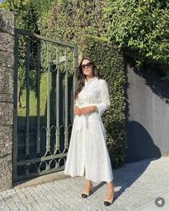 Close-up of white eyelet lace embroidery detail on a cotton midi shirt dress with belt