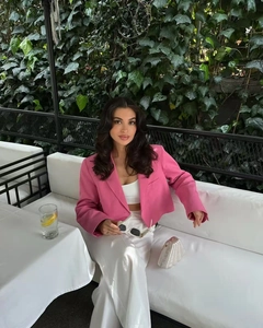 Close-up of a pink cropped blazer featuring classic lapels and a single-breasted design