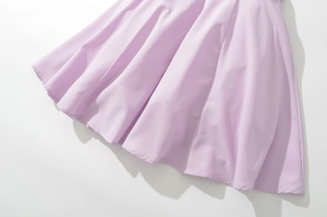 Detail view of lavender lace dress hem with elegant pleated texture and fine stitching