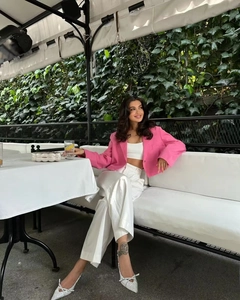 Detail of a pink cropped blazer and high waist wide leg trousers for a street style look
