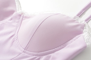Close-up of lavender lace trim and mesh fabric details on a padded summer dress