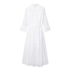Rear view of white midi dress with intricate eyelet embroidery and a waist tie belt