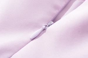 Detailed macro view of an invisible zipper closure on a lavender lace summer dress