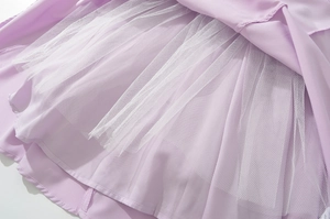 Detail of lavender woven fabric with white tulle layering and fine hem stitching on dress
