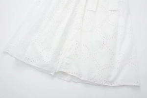 Detailed view of intricate white eyelet embroidery on high-quality cotton midi dress