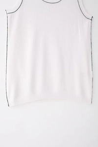 Close-up of white knit tank top with black contrast stitching and ribbed hem detail