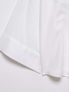 Detailed view of the stitching and fabric texture on white cotton batwing sleeve shirt