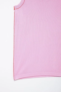 Detail view of pink knit tank top featuring red contrast stitching and soft fabric texture