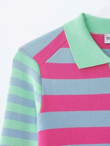 Detailed macro view of mint green polo collar and colorful striped ribbed knit fabric