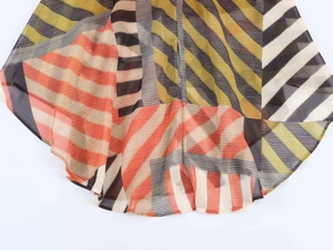 Macro detail of patchwork geometric print on lightweight semi-transparent chiffon dress