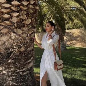 Elegant white embroidered eyelet midi dress with belt and vintage crossbody bag