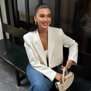 Women's trendy white cropped blazer jacket featuring clean lapels and a tailored slim fit