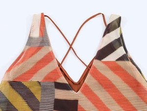 Detail of V-neck patchwork printed dress with cross thin straps and striped texture