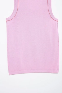 Detail view of pink knit tank top featuring red contrast stitching on seams and edges