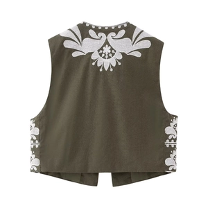 Vue détaillée de la broderie florale blanche sur le gilet sans manches olive foncé