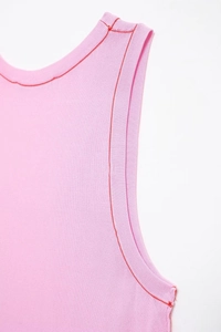 Close-up of pink ribbed knit vest featuring contrast red decorative stitching details