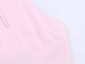Close-up of pink poplin fabric texture showing neat stitching and matching drawstring detail