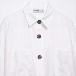 Women's loose white batwing sleeve shirt featuring lapel collar and marble pattern buttons