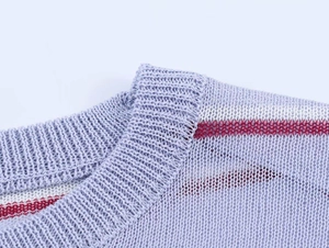 Detailed view of striped crew neck collar and knit texture on this blue summer top