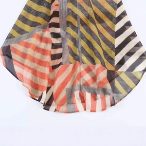 Colorful striped patchwork summer beach dress in lightweight pleated fabric and wavy hemline