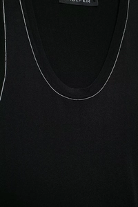 Detailed close-up of the black knit top featuring elegant silver chain link trim at the neckline