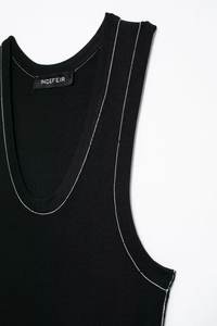 Close-up of black knit tank top featuring contrasting white stitching and U-neck detail