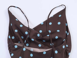 Detail showing the brown polka dot fabric and adjustable spaghetti straps of the camisole