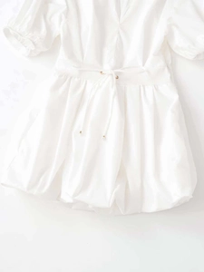 Detail of white V-neck poplin mini dress with puff sleeves and cinched waistline