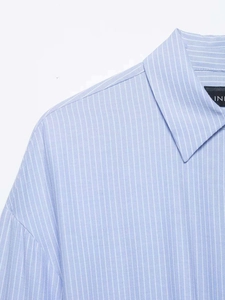 Close-up of blue and white vertical striped shirt collar with fine fabric texture