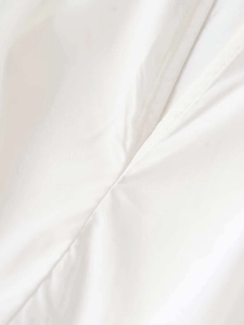 Detailed view of the V-neckline and ruched poplin fabric on this white mini dress