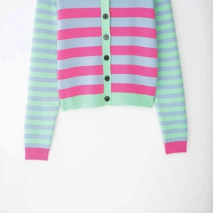 Colorful striped knit cardigan featuring pink and blue patterns with green ribbing detail