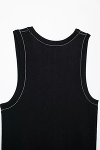Detail of black ribbed knit vest with white contrast stitching on neckline and straps