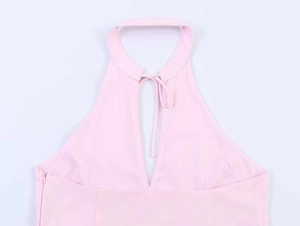 Detail of pink halter neck poplin dress showing stand collar with front tie and deep V-neck