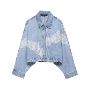 Detail of light blue denim jacket featuring white floral lace patchwork on sleeves