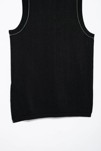 Detailed macro view of the black knit tank top with white contrast stitched edges