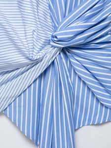 Close-up of twist detail and pleated texture on blue and white striped summer dress
