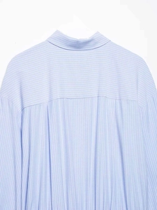 Detailed close-up of striped dress back showing horizontal yoke and vertical pleats