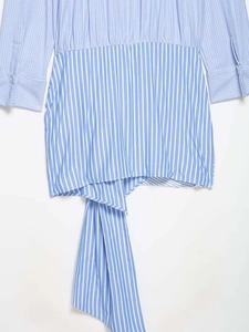 Detail of blue and white vertical striped dress with cinched waist and tie belt