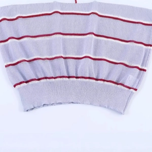 Close-up of a striped knit top hem with lavender, white, and dark red horizontal patterns